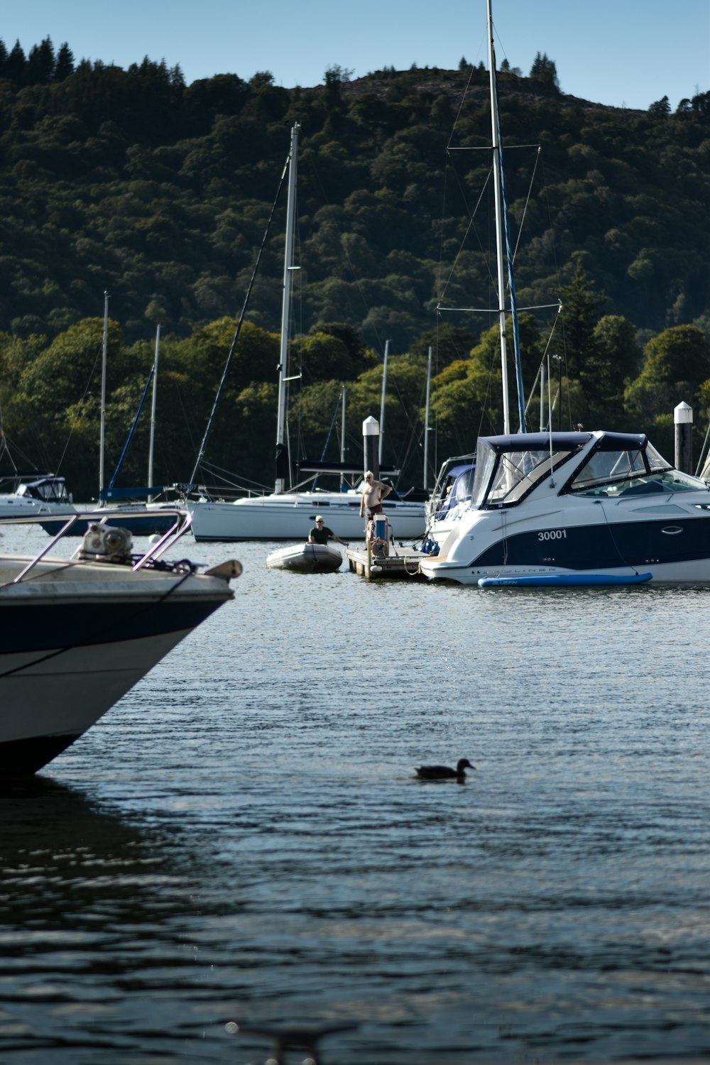 a group of boats floating on top of a lake