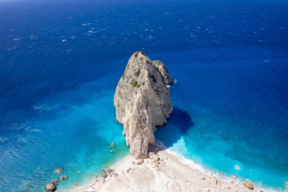 a large rock sticking out of the ocean