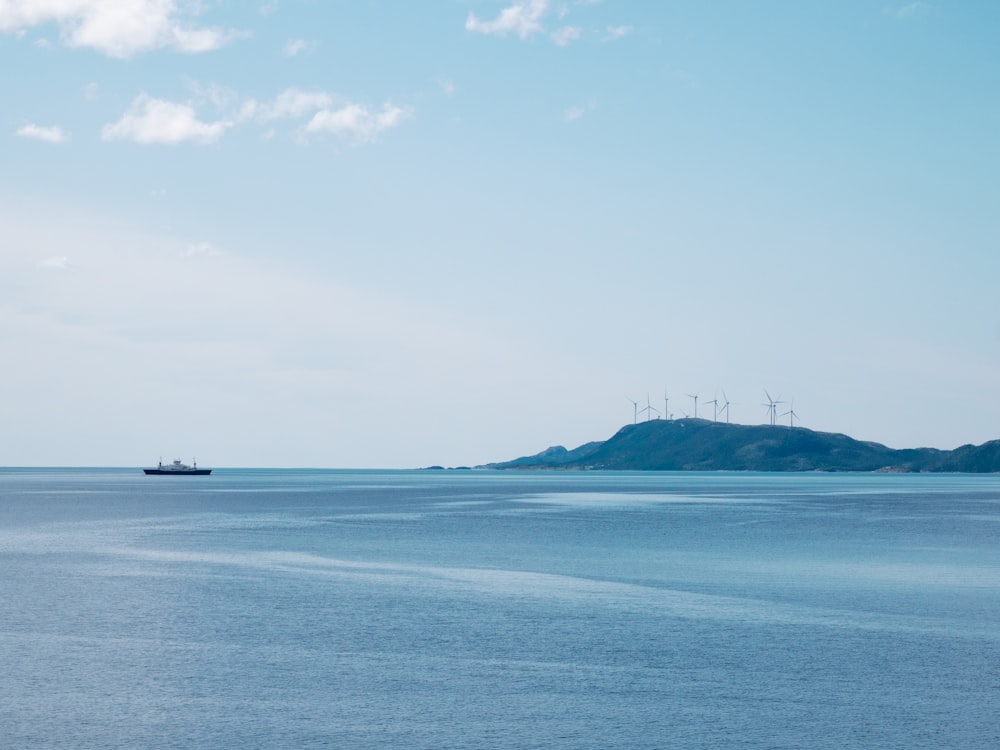 a large body of water with a boat in the distance