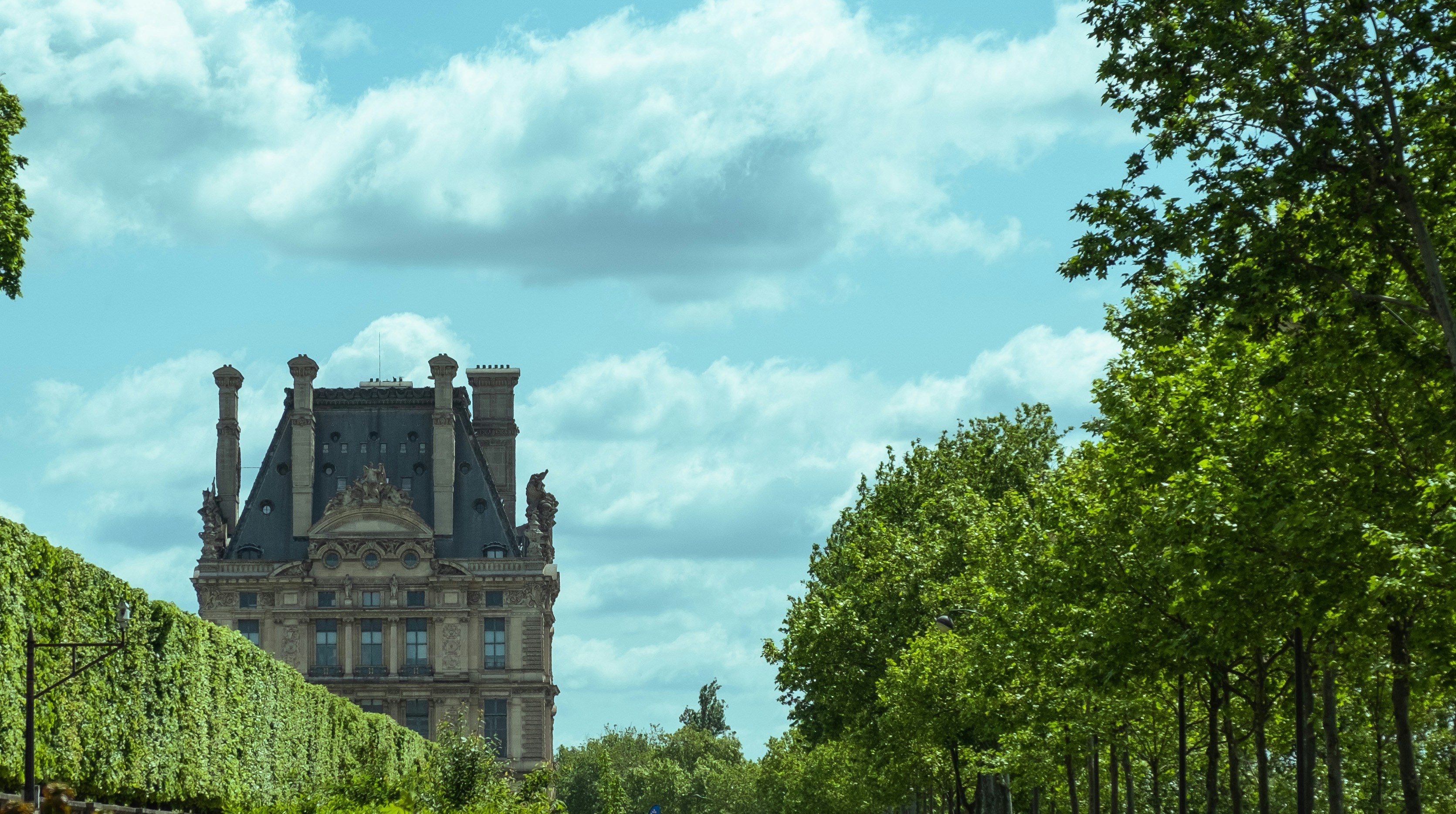 a very tall building surrounded by lots of trees