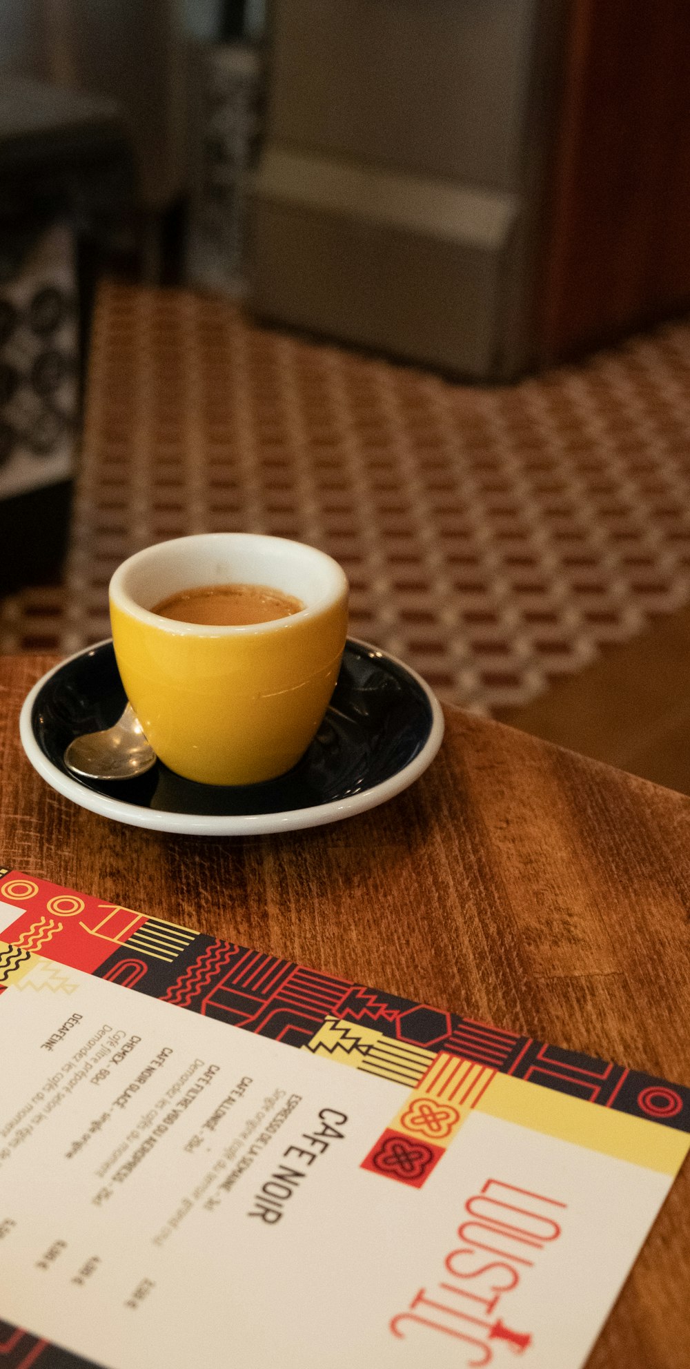 a cup of coffee sitting on top of a table