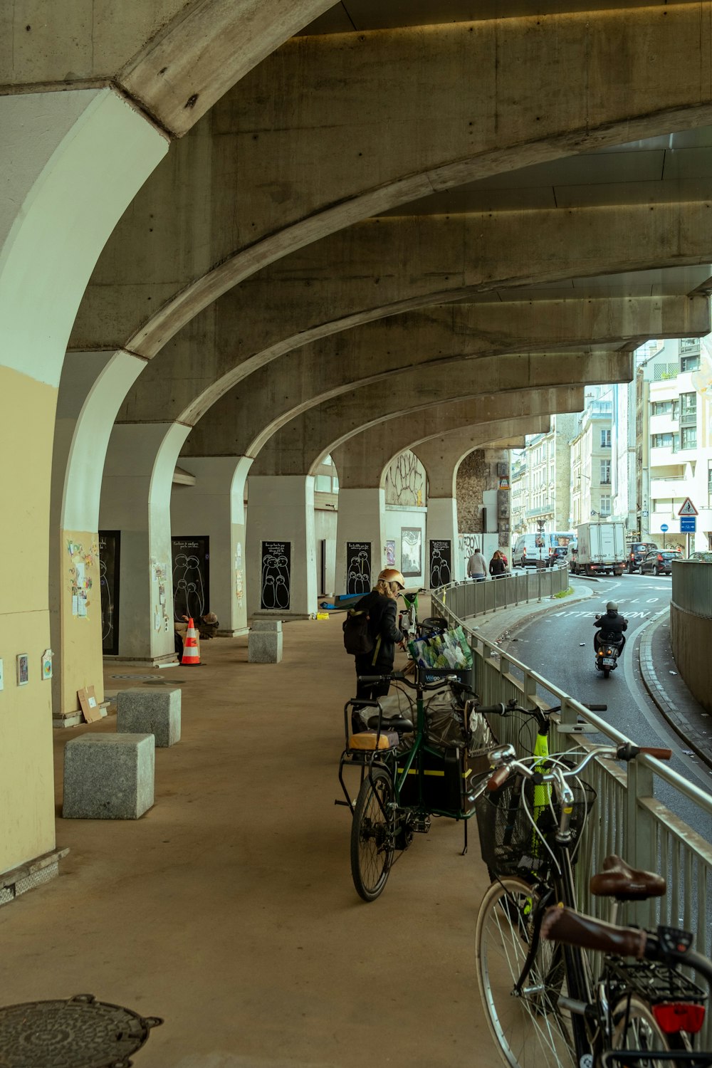 a group of bikes parked next to each other under a bridge