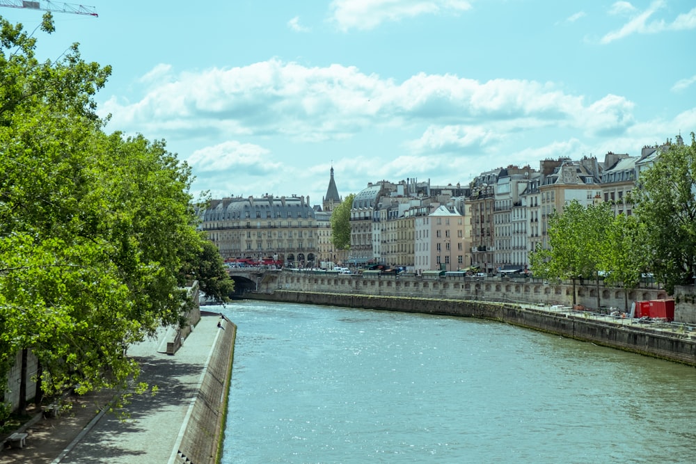 a river running through a city next to tall buildings