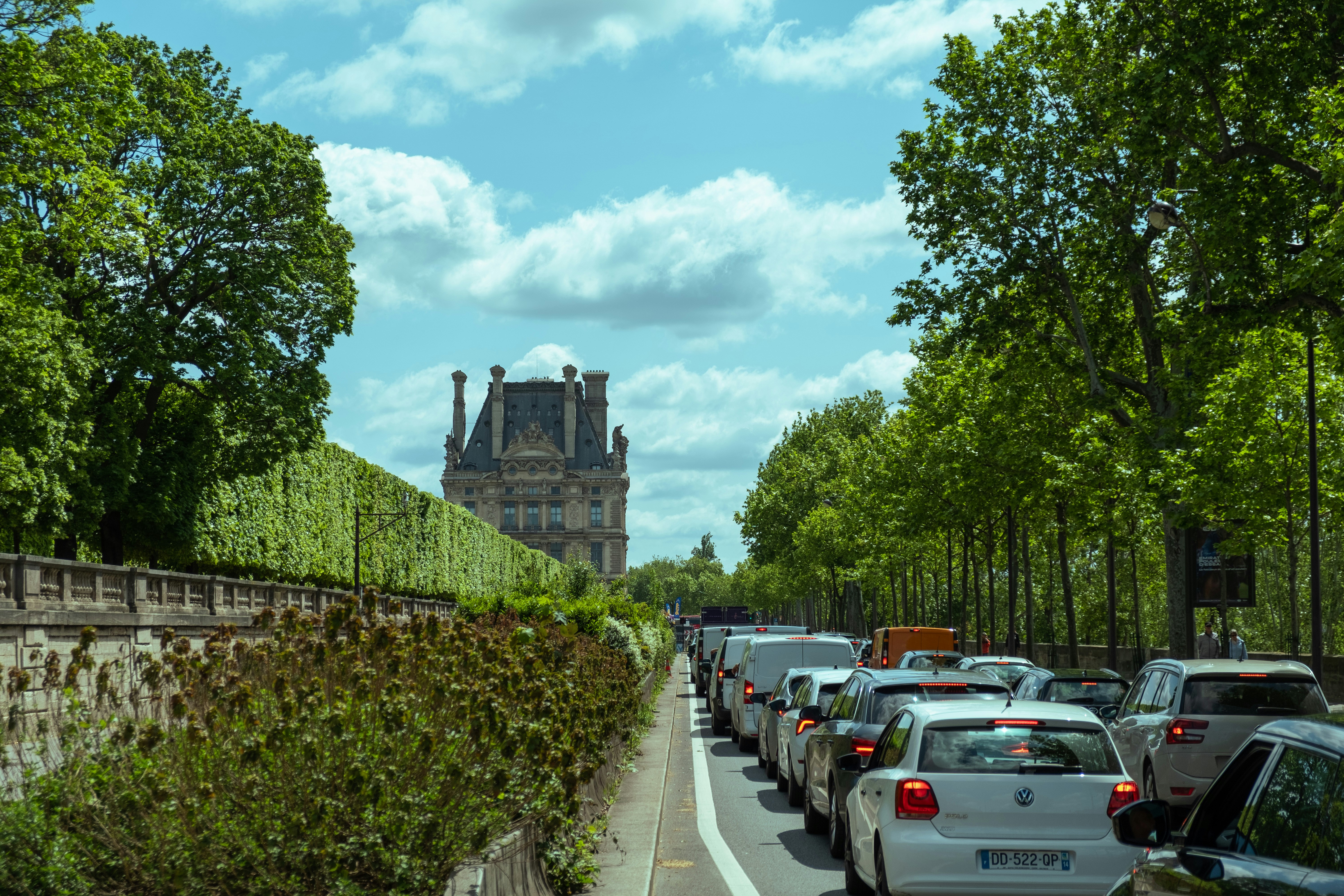 Una strada piena di molto traffico accanto a un edificio alto