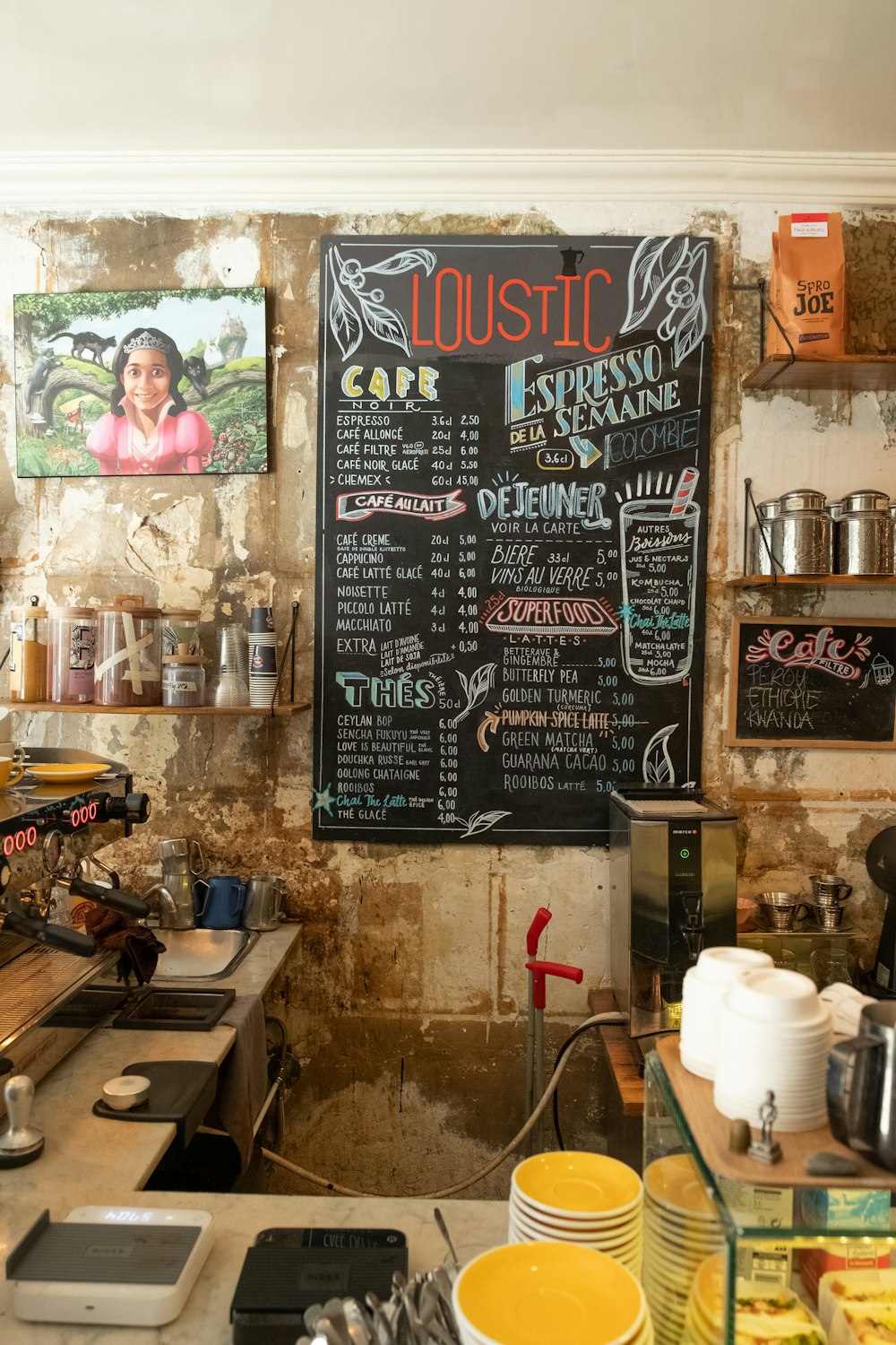 a restaurant with a chalkboard menu on the wall