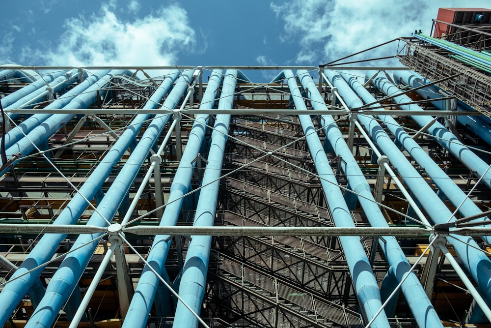 a very tall building with lots of blue pipes