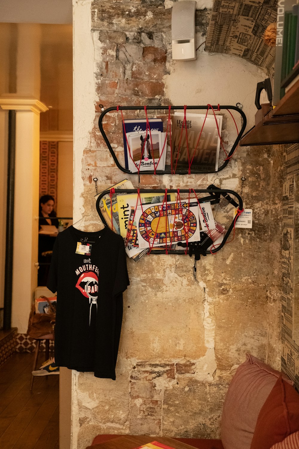 a surfboard and a t - shirt hanging on a wall
