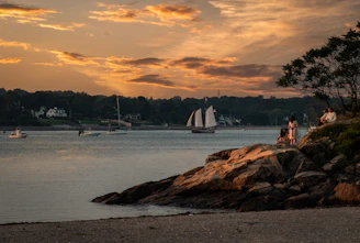 Sunset view of Ilhabela coastline with boats ready for diving excursions.