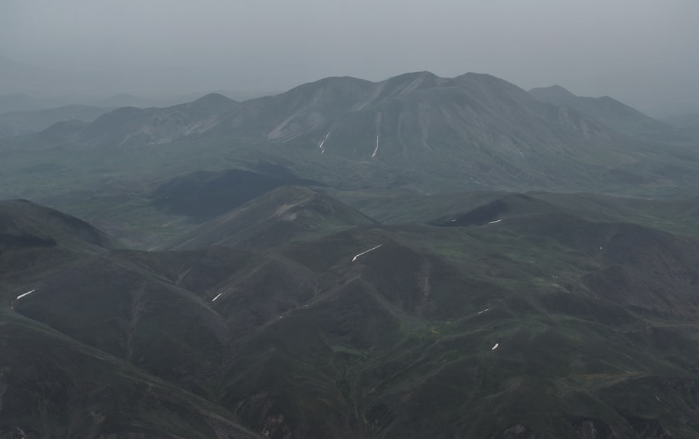 a view of a mountain range in the fog