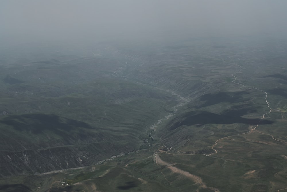 an aerial view of a valley in the fog