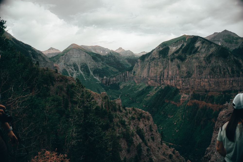 a person standing on a cliff overlooking a valley