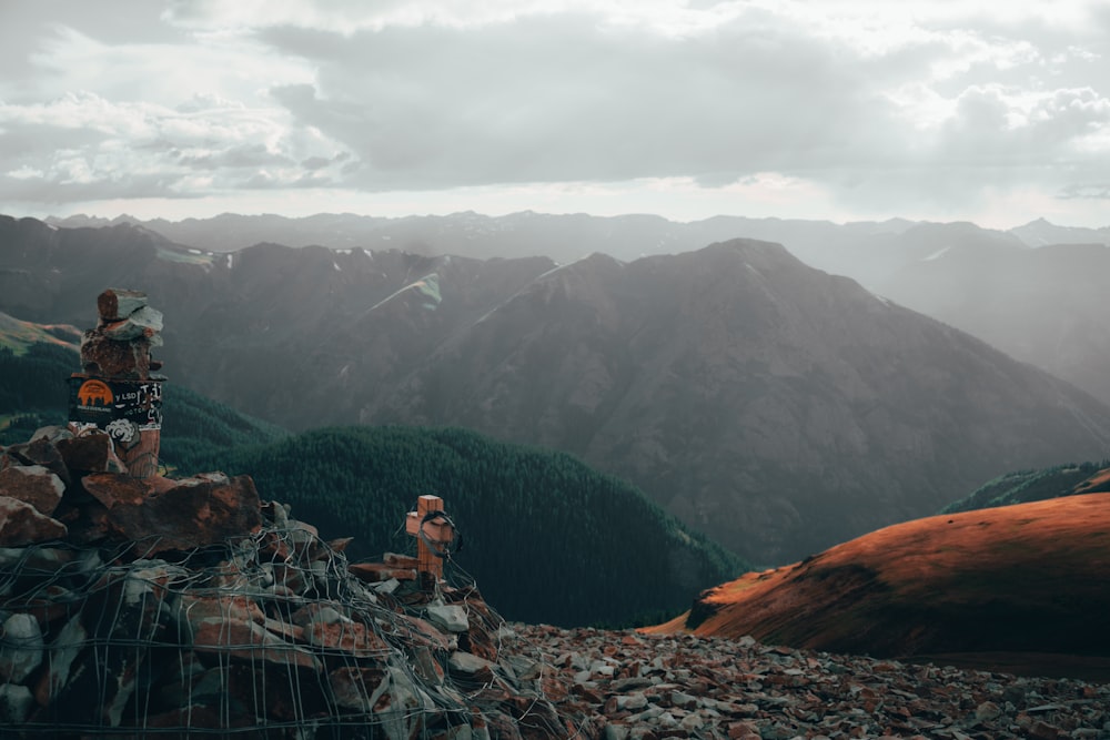 a couple of people standing on top of a mountain