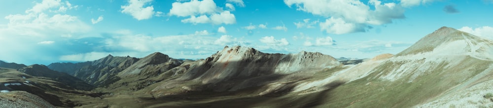 a man riding a snowboard down the side of a snow covered mountain