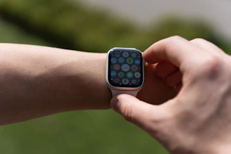 Close-up of hands holding a smartwatch designed for seniors.