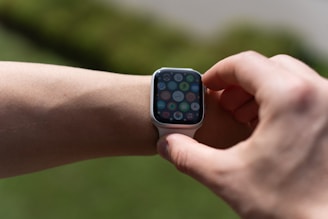 A close-up of a smart wearable device displaying notifications on its screen.