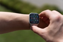 Close-up of hands adjusting wearable biohacking technology on wrist.