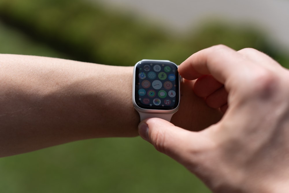 a close up of a person holding an apple watch