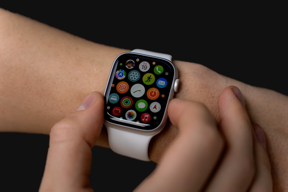a close up of a person holding an apple watch