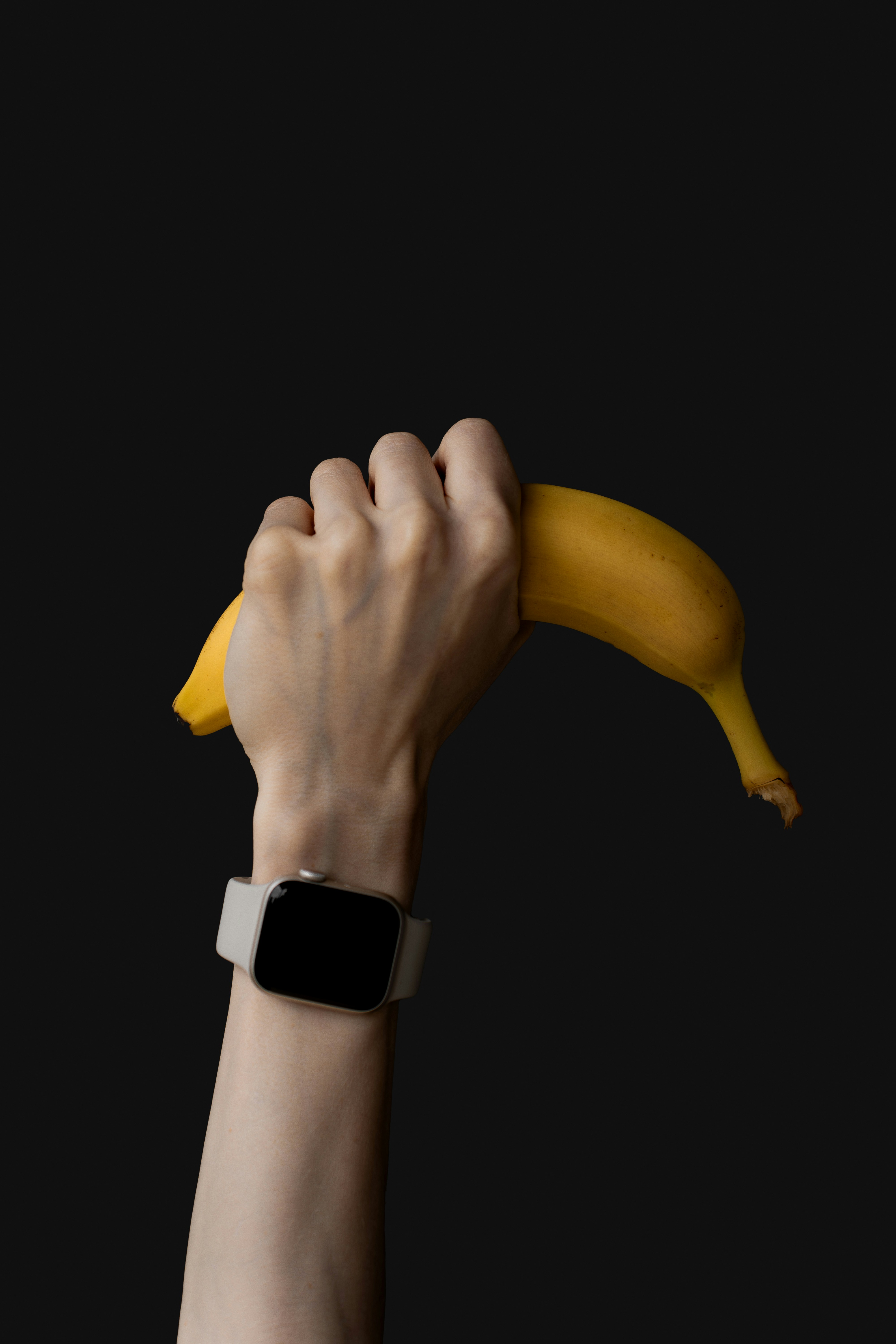 a person is holding a banana in their hand