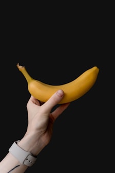 a person holding a banana in their hand