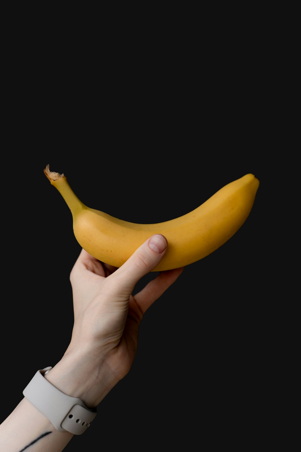 a person holding a banana in their hand