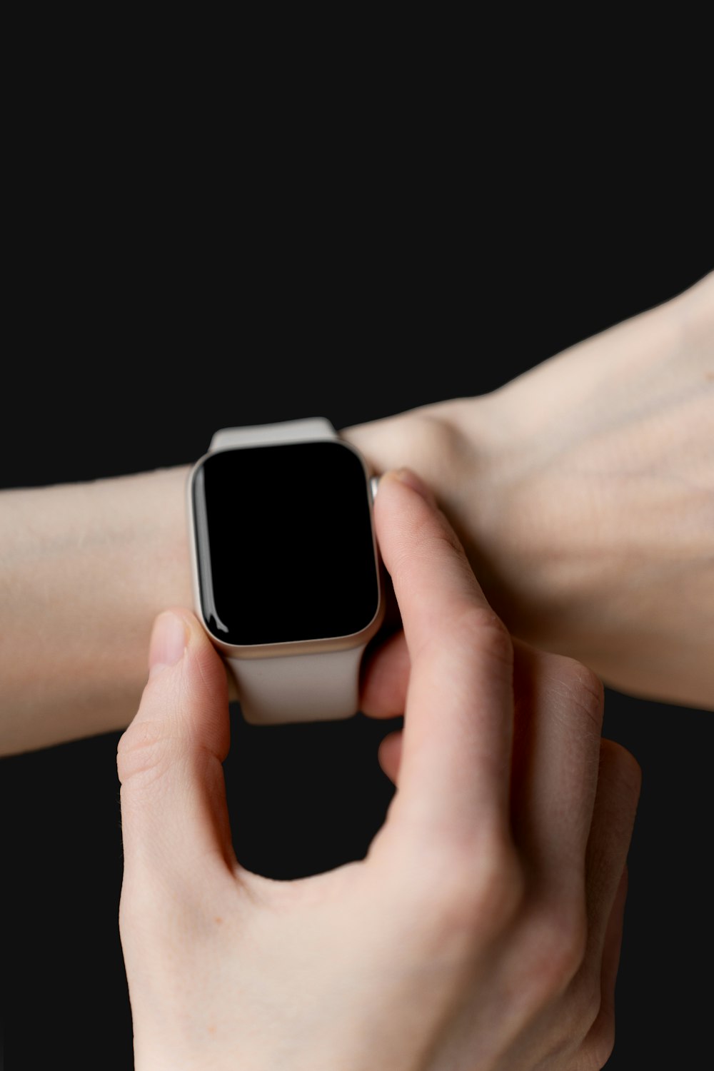 a person holding an apple watch in their hand