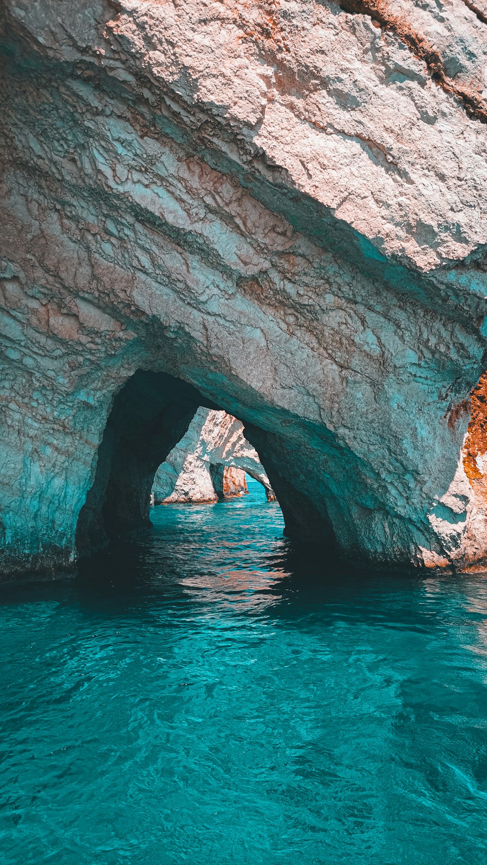 a large rock formation in the middle of a body of water