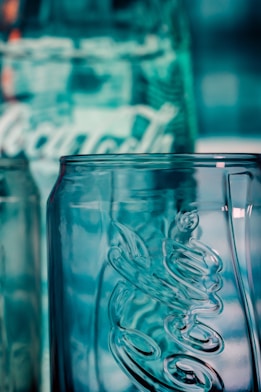 A close-up of a crystal-clear water bottle with light reflecting off its surface.
