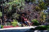 A couple sharing a quiet moment sitting on a blanket near blooming flowers in a sunny park.