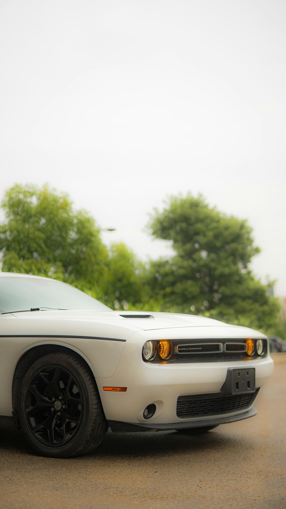 a white sports car parked in a parking lot