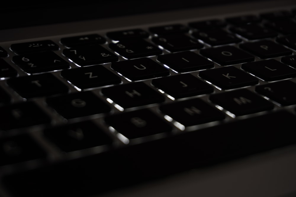 a close up of a black keyboard in the dark