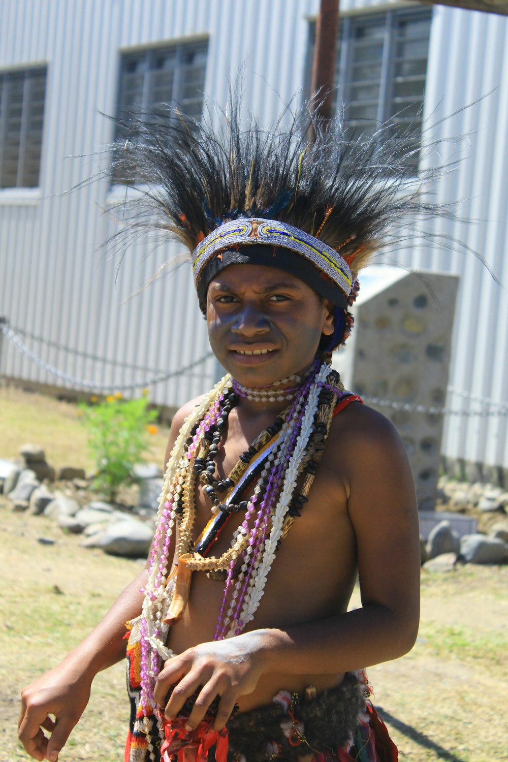 a native american man wearing a headdress and beads