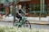 A happy customer riding an electric bike in an urban setting.