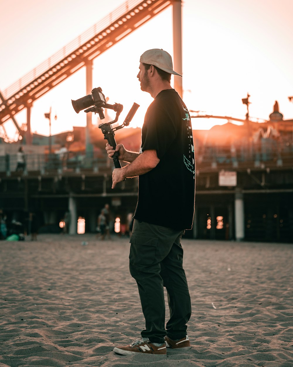 a man standing on a beach holding a baseball bat