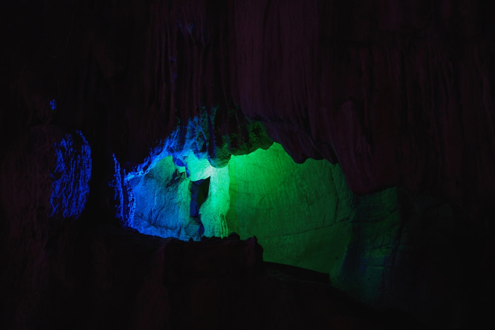 a group of people standing inside of a cave