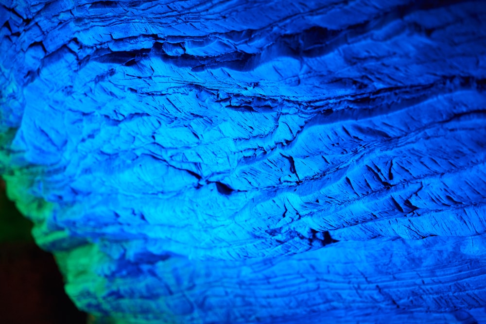 a close up of a blue and green wall