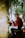 a man sitting on a bench playing a guitar