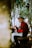 a man sitting on a bench playing a guitar
