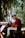 a man sitting on a bench playing a guitar