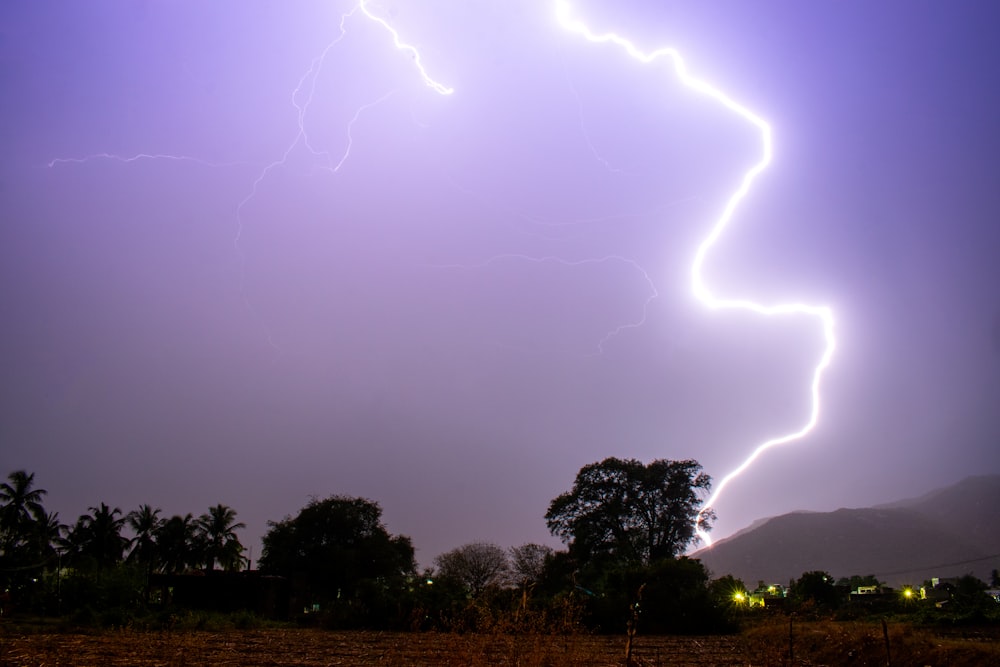 a lightning bolt is seen in the sky above a field