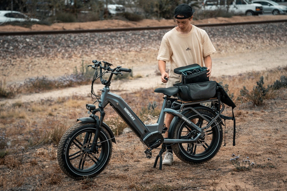 a man standing next to a parked bike