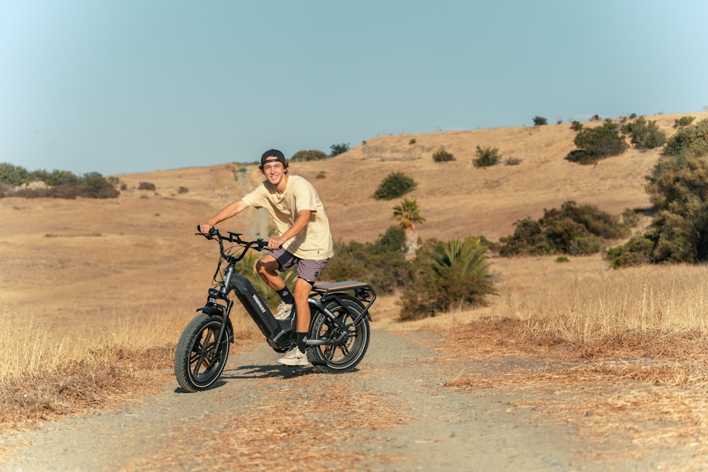 a man riding a scooter down a dirt road
