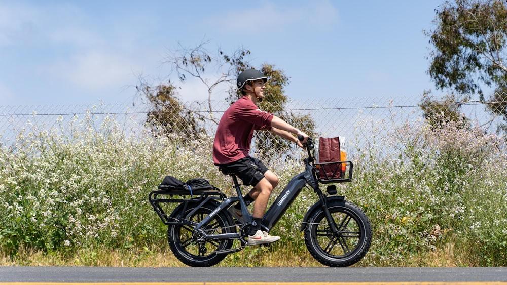 a man riding a bike down a street