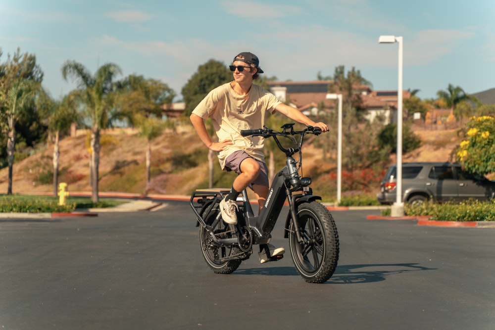 a man riding a bike in a parking lot