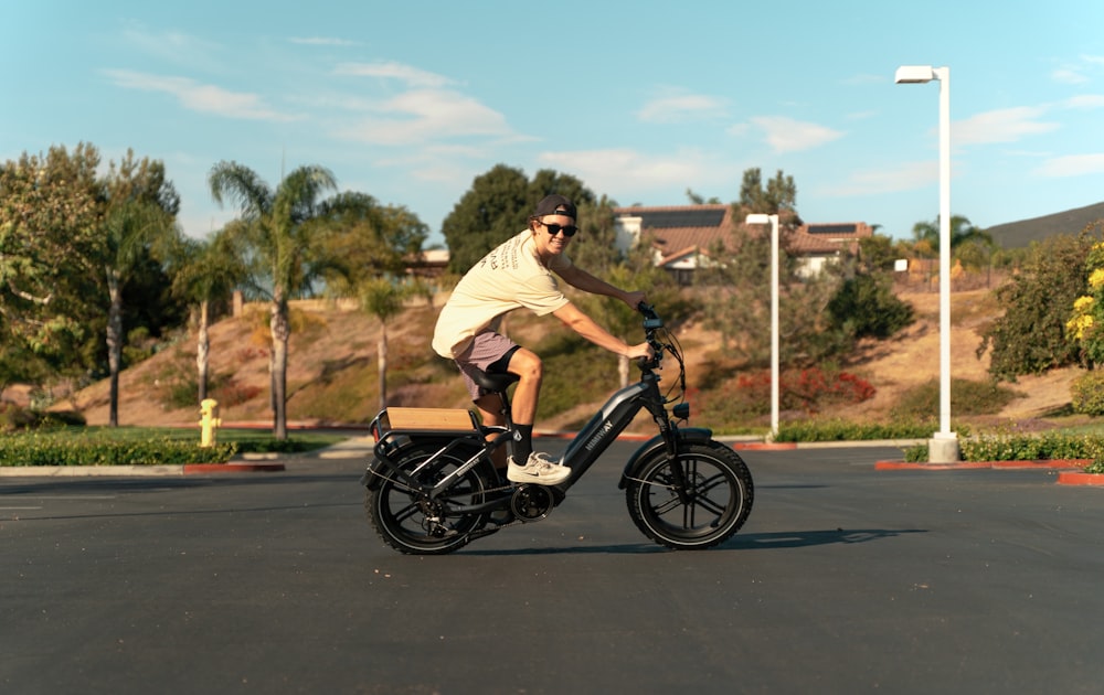 a man riding a bike in a parking lot