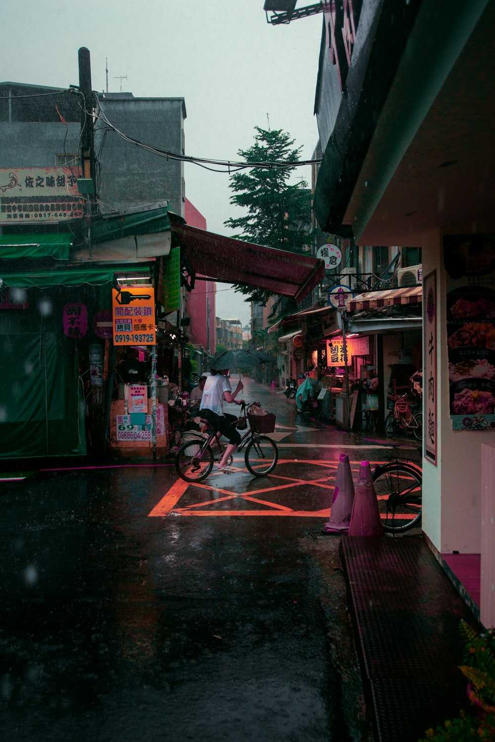 a person riding a bike down a wet street