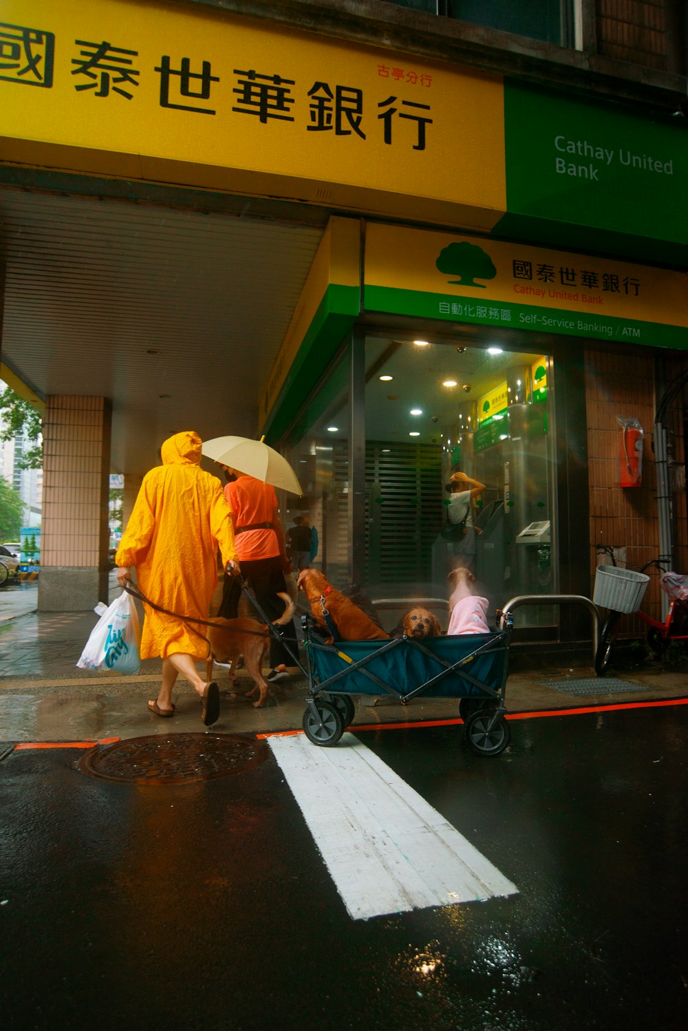 a group of people walking down a street with a baby carriage