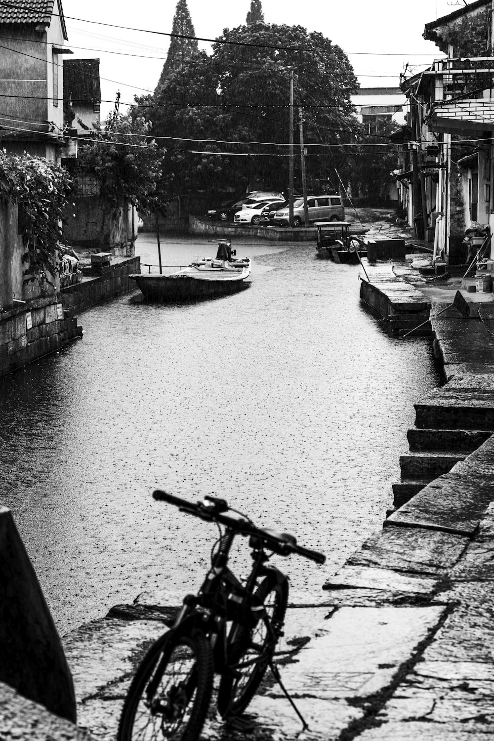 a bicycle parked on the side of a river