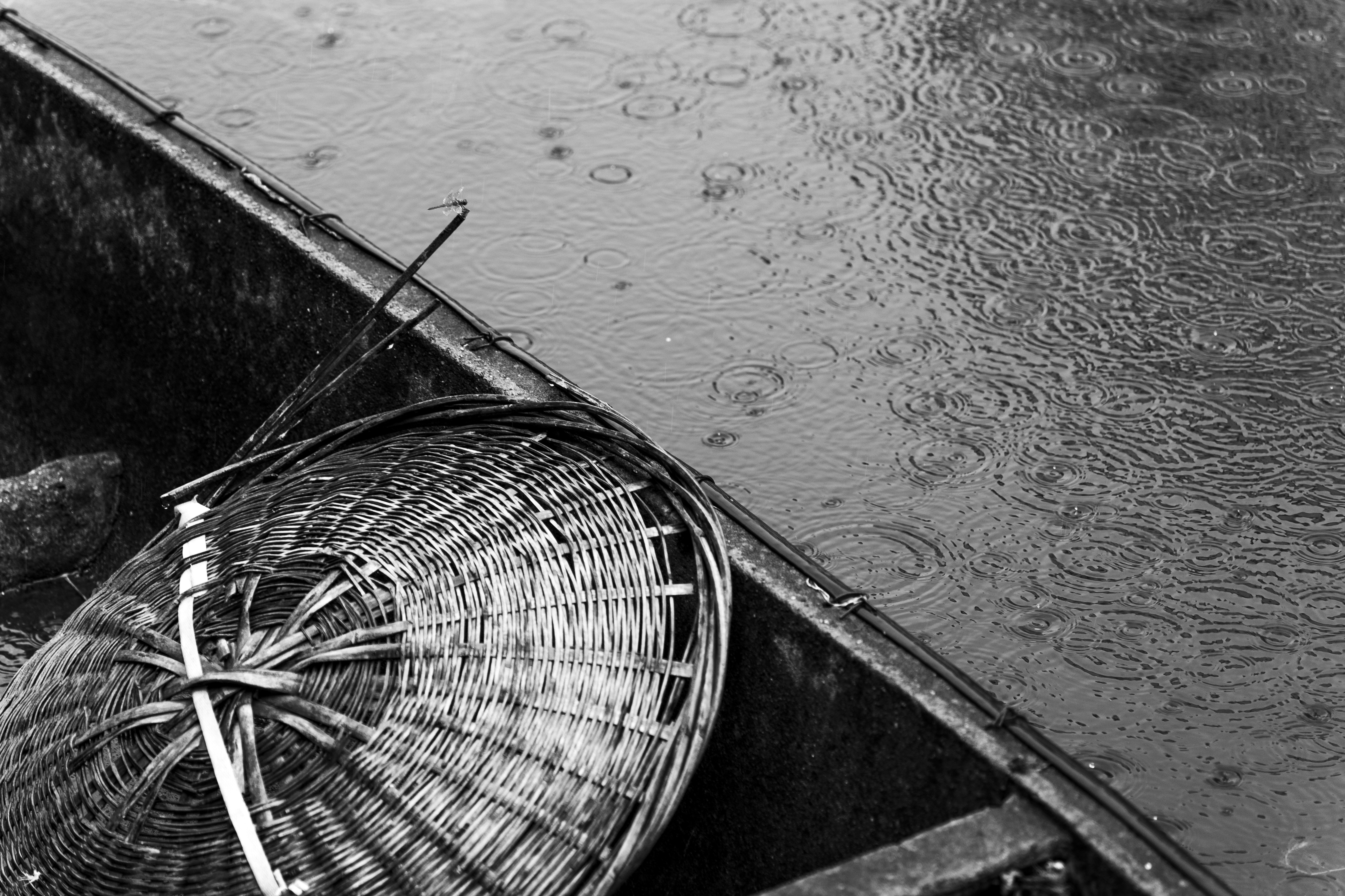 a black and white photo of a basket in a boat, 