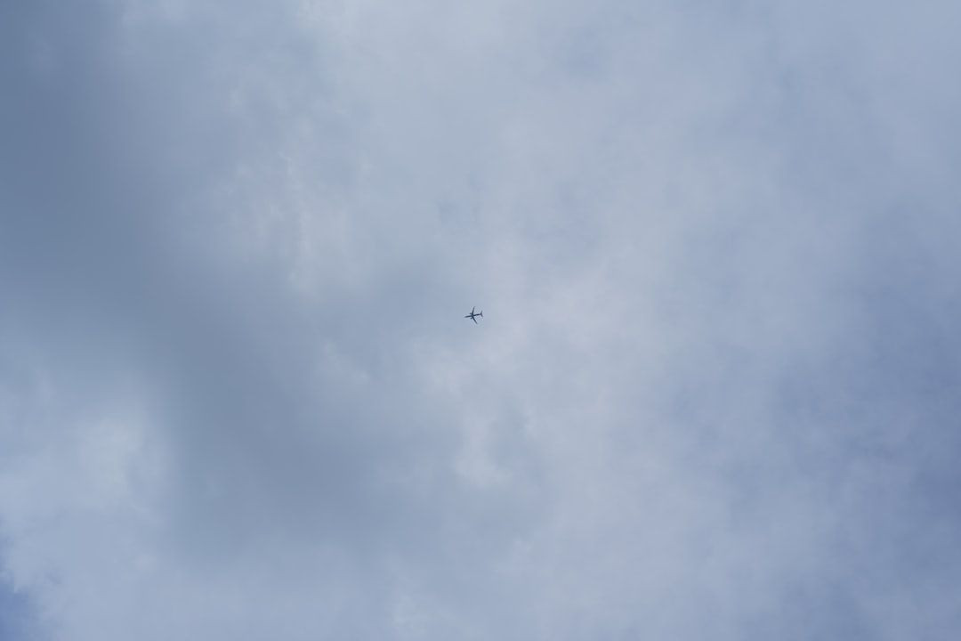 an airplane is flying high in the sky,